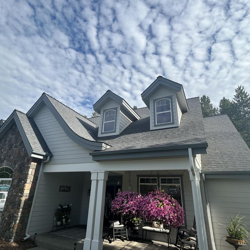 Asphalt shingle roof with dormer windows and flower decor Asphalt shingle roof with dormer windows and flower decor