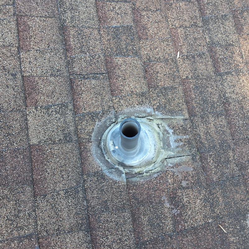 Roof vent pipe flashing with damaged seal on shingles