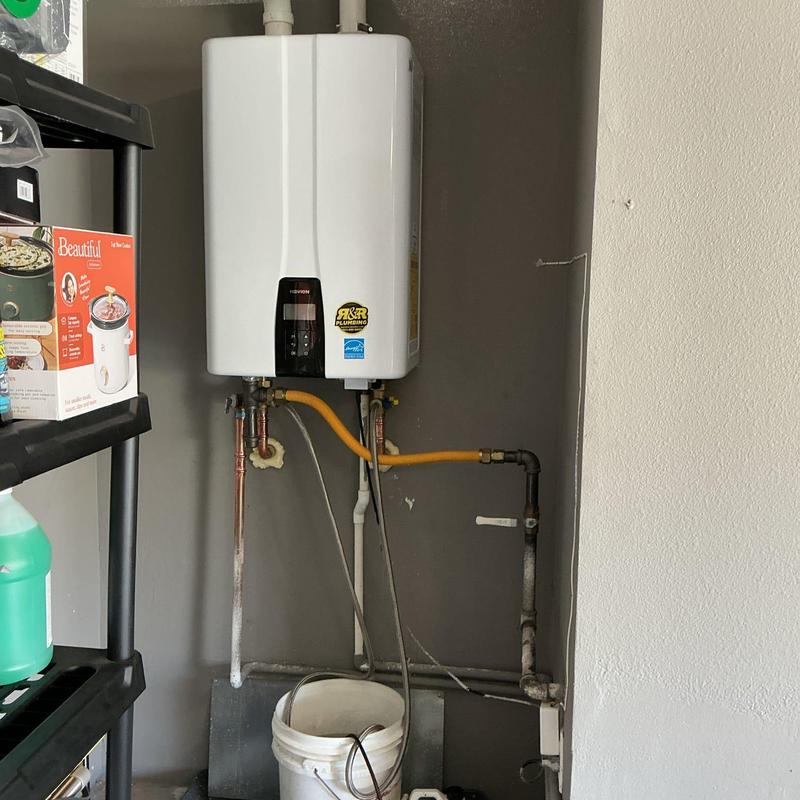 Tankless water heater with flush setup in utility room