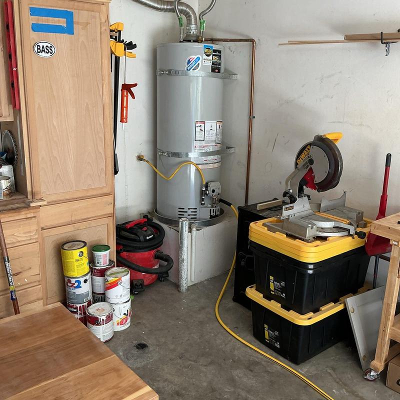 Water heater with sediment flush in garage workspace