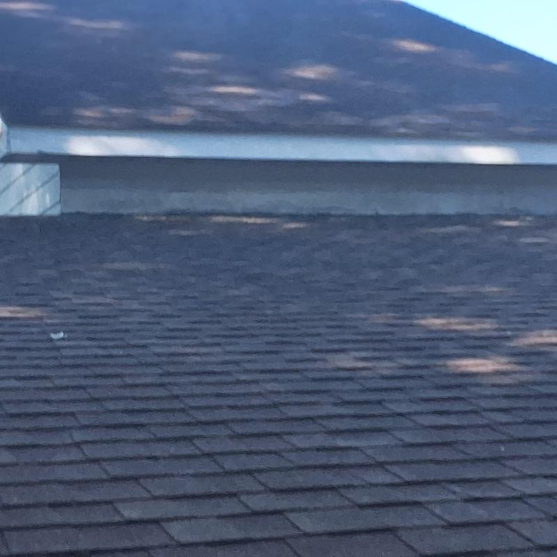Shingle roof with aging wear on residential home