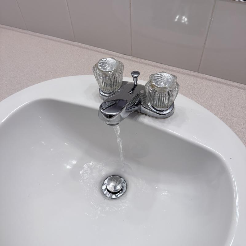 Bathroom faucet with running water and drain stopper
