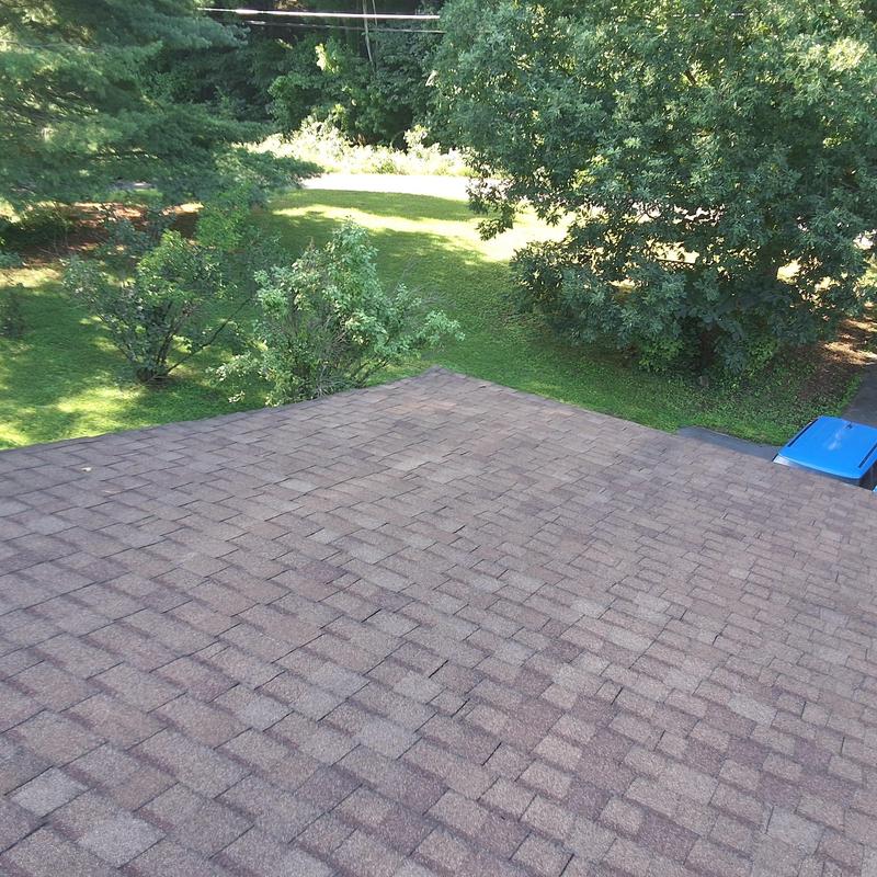 Asphalt shingle roof with visible wear and aging