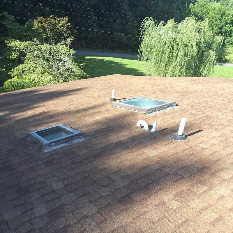 Skylights and roof vent flashing on shingle roof