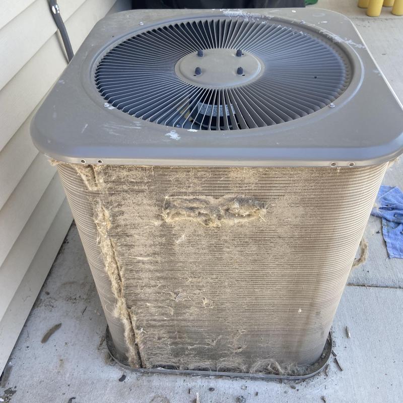 Outdoor air conditioner condenser coil clogged with debris Outdoor air conditioner condenser coil clogged with debris