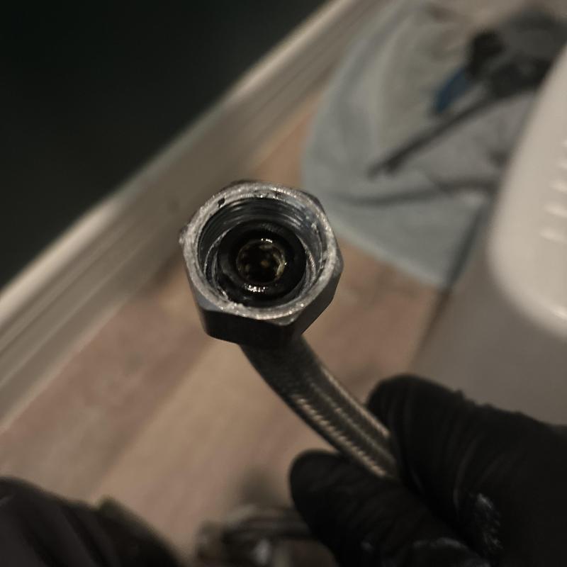 Price Pfister shower cartridge hose fitting close-up
