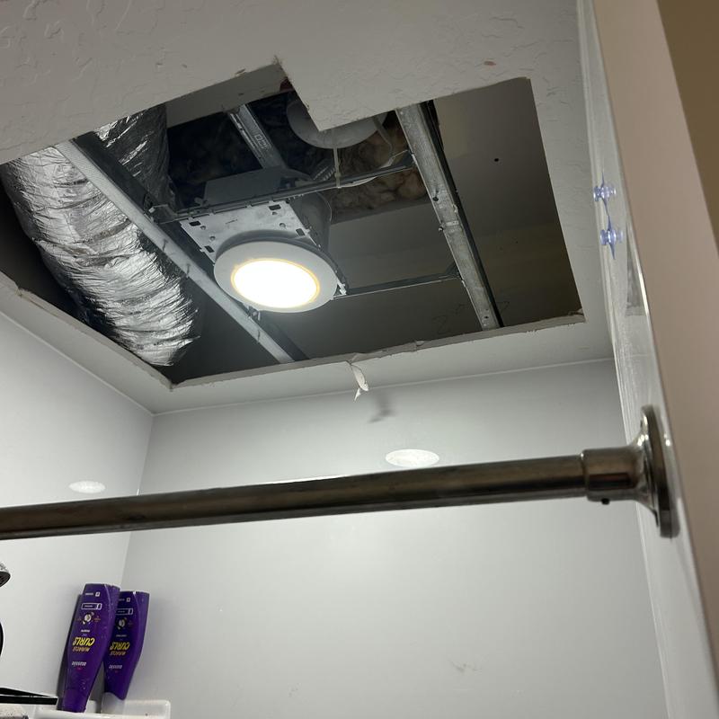 Ceiling exhaust fan with ductwork in bathroom ceiling cavity Ceiling exhaust fan with ductwork in bathroom ceiling cavity