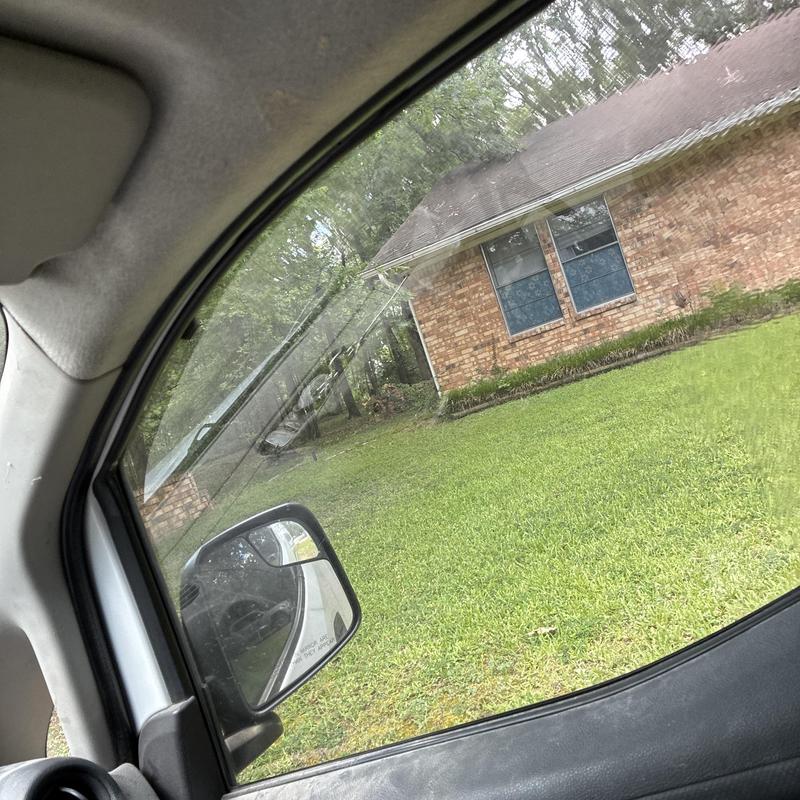 Window and brick exterior view from vehicle window Window and brick exterior view from vehicle window
