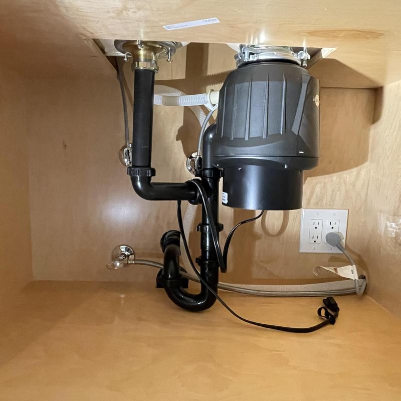Garbage disposal and tubular drain piping installation under sink