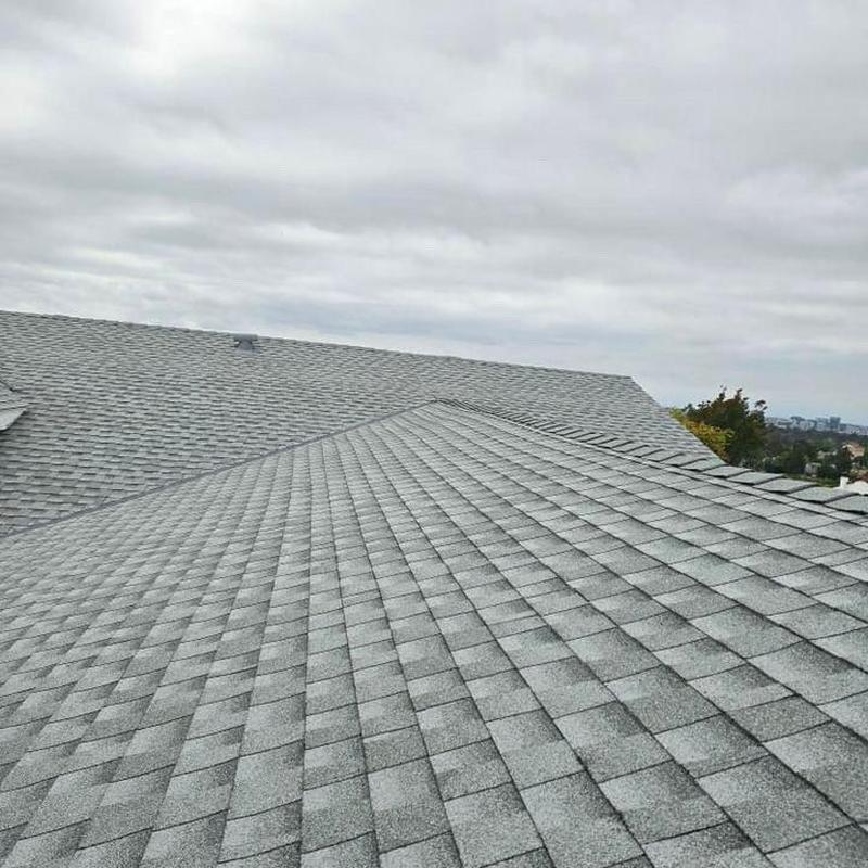Gray architectural shingles roof installation on residential home Gray architectural shingles roof installation on residential home