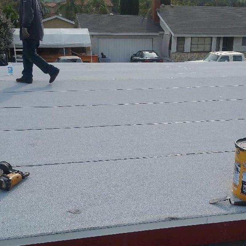 Flat roofing membrane installation on residential roof Flat roofing membrane installation on residential roof