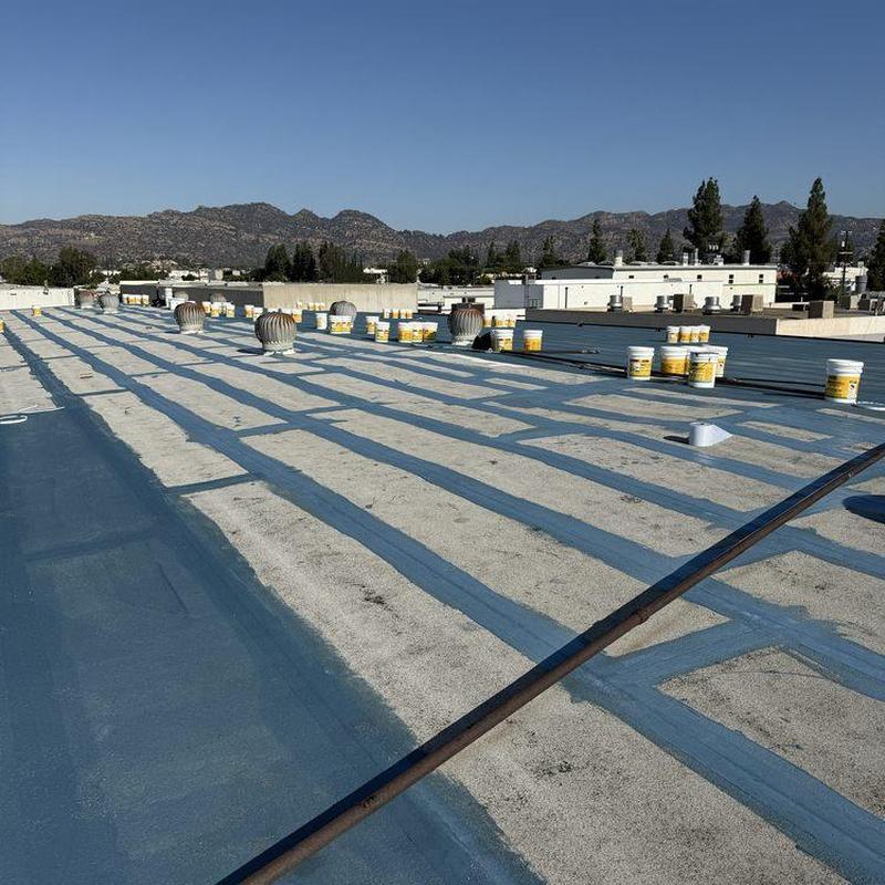 Flat roof waterproofing with sealed seams and coating Flat roof waterproofing with sealed seams and coating