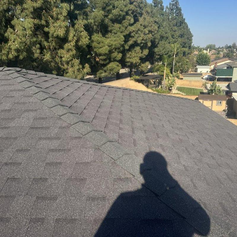 New asphalt shingle roof installation with shadow New asphalt shingle roof installation with shadow