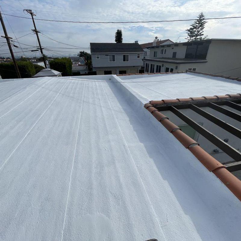 Commercial flat roof with white reflective coating Commercial flat roof with white reflective coating