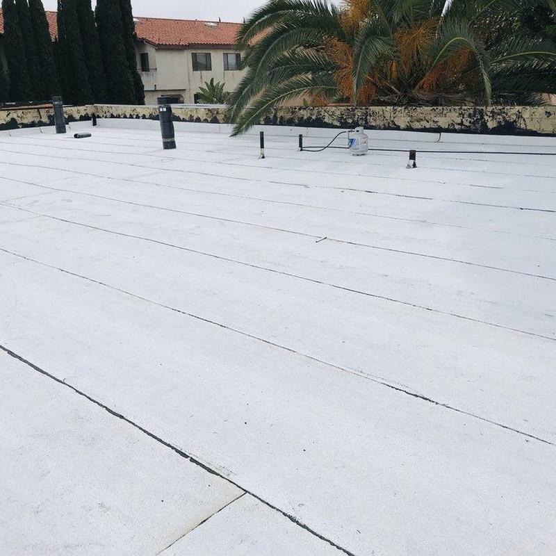 Flat roof with white membrane and vent pipes Flat roof with white membrane and vent pipes