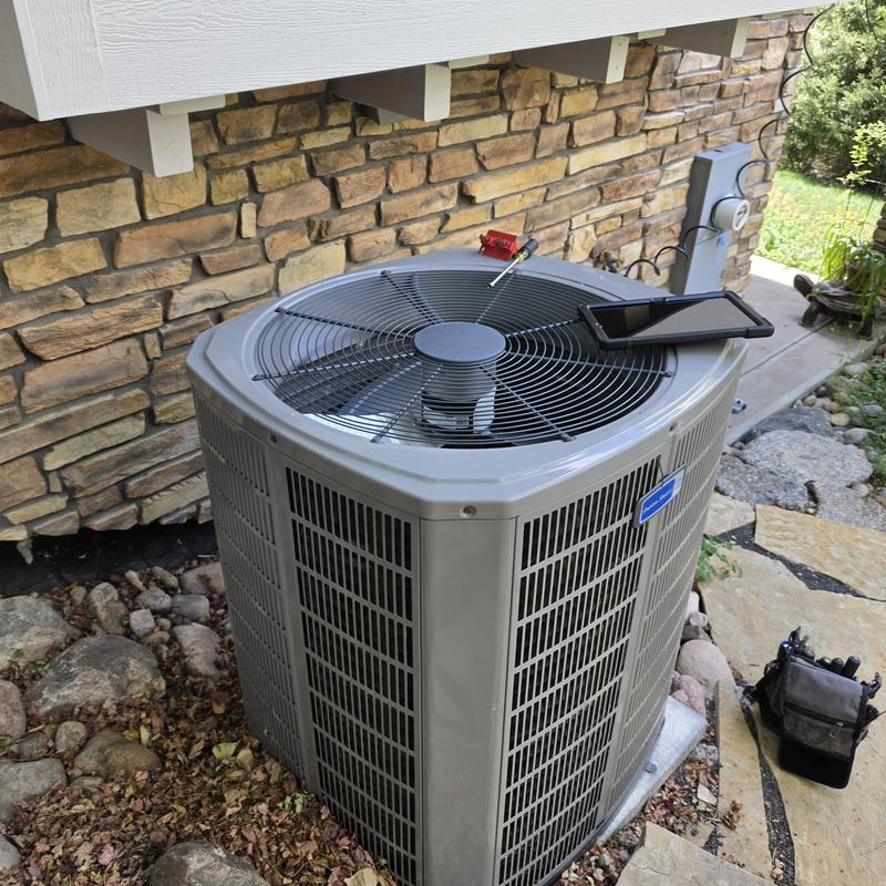 American Standard air conditioner unit with tools nearby