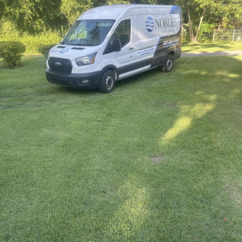 HVAC service van parked on grassy lawn in Tallahassee