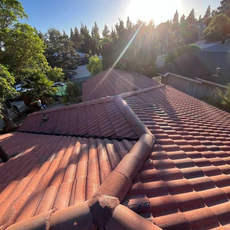 Tile roof ridge and vent inspection in sunlight Tile roof ridge and vent inspection in sunlight