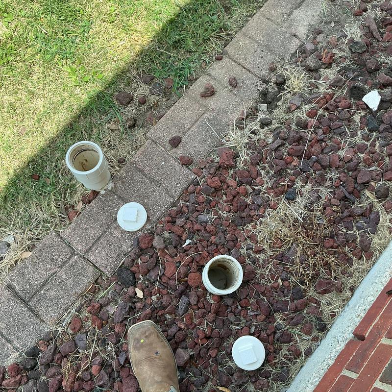 PVC plumbing cleanouts with caps removed on ground surface PVC plumbing cleanouts with caps removed on ground surface