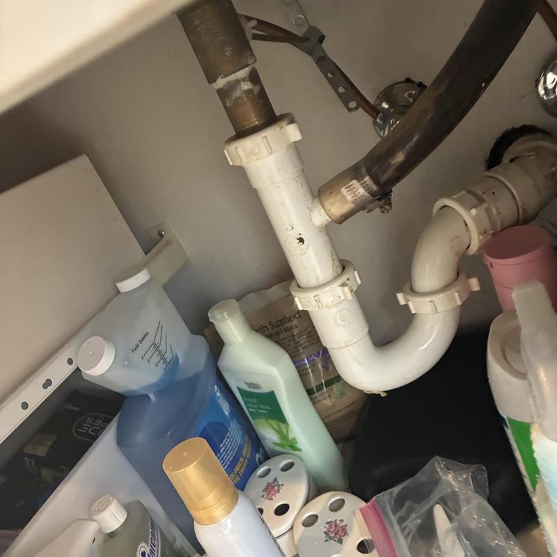 P-trap drain pipe under sink with cleaning supplies P-trap drain pipe under sink with cleaning supplies
