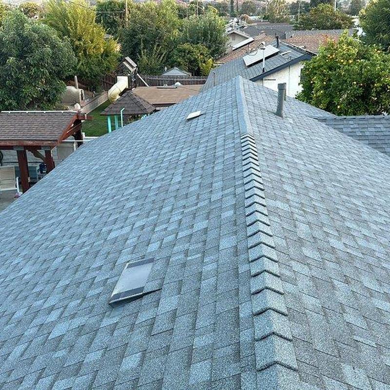 Asphalt shingle roof installation with ridge cap detail Asphalt shingle roof installation with ridge cap detail