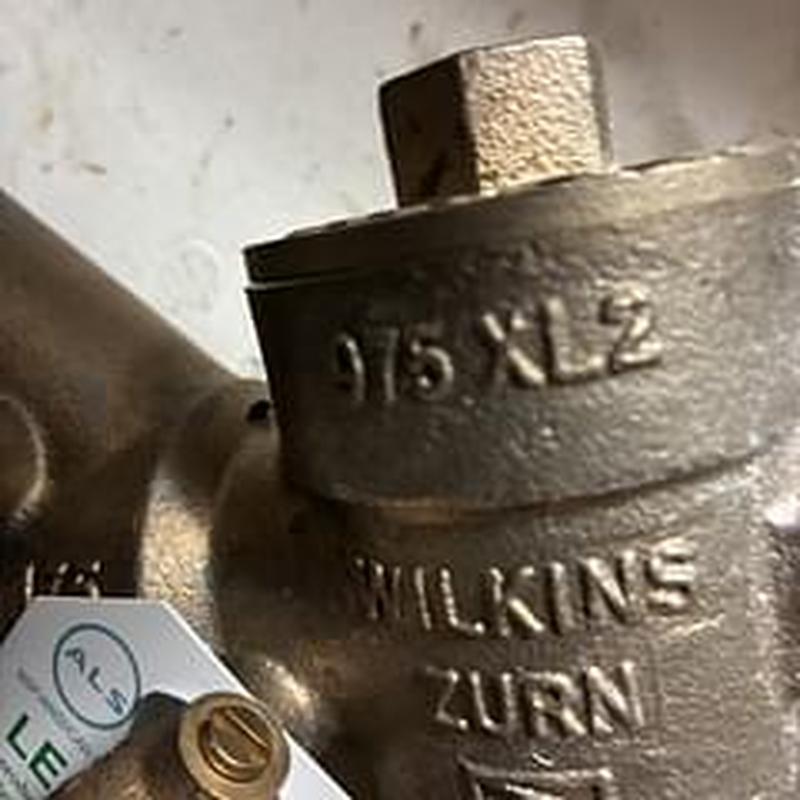 Backflow prevention valve close-up with tag Backflow prevention valve close-up with tag