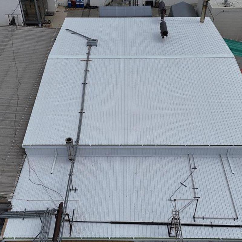 Flat white metal roof with vents and piping Flat white metal roof with vents and piping