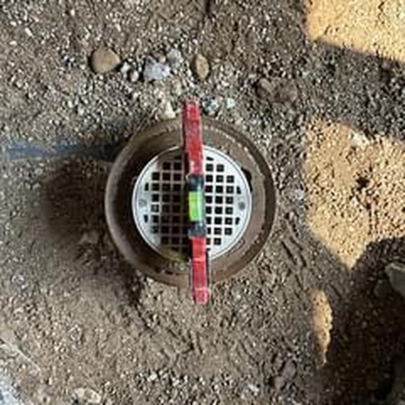 Floor drain installation in gravel base with level tool Floor drain installation in gravel base with level tool