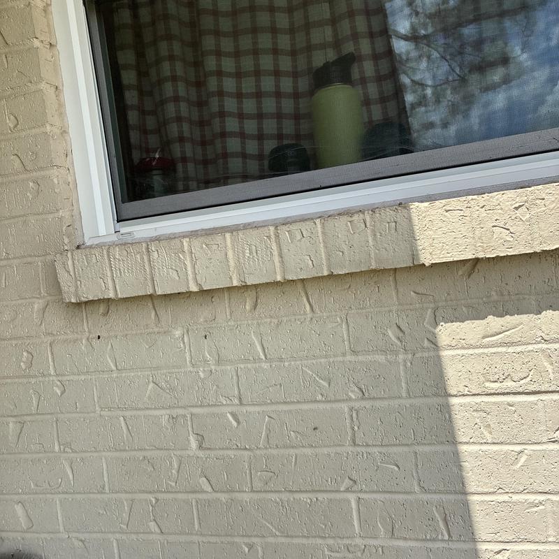 Window frame and exterior brick wall in natural light Window frame and exterior brick wall in natural light