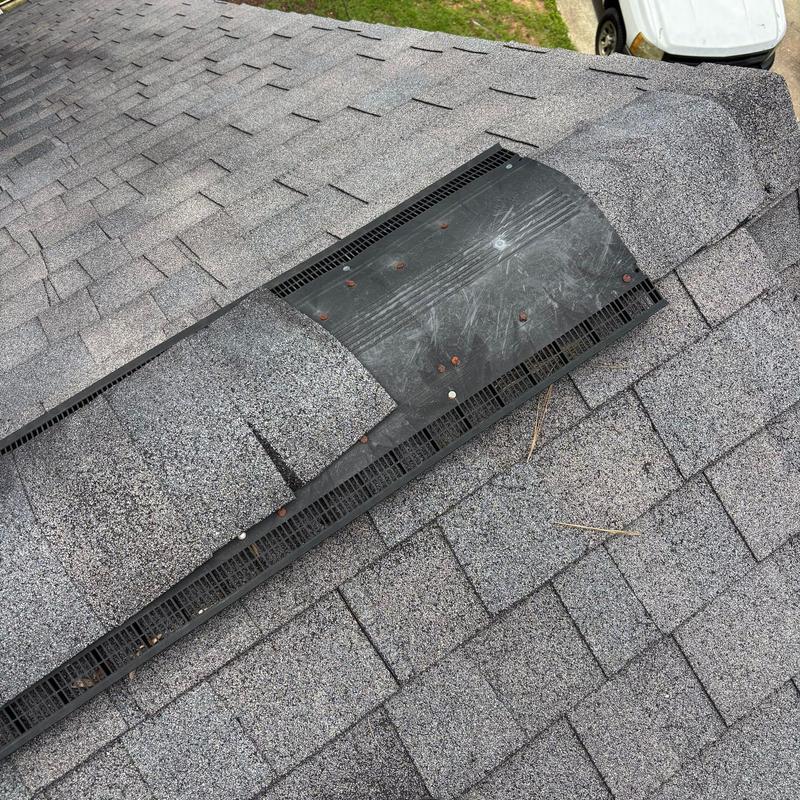 Ridge vent with missing cap shingles and exposed nails