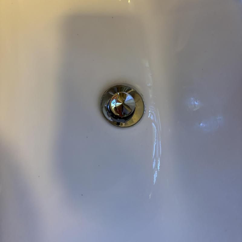 Bathroom sink brass pop-up drain assembly installed