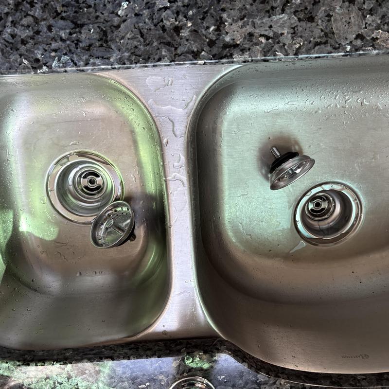 Kitchen sink pop-up drain assemblies removed in stainless sink