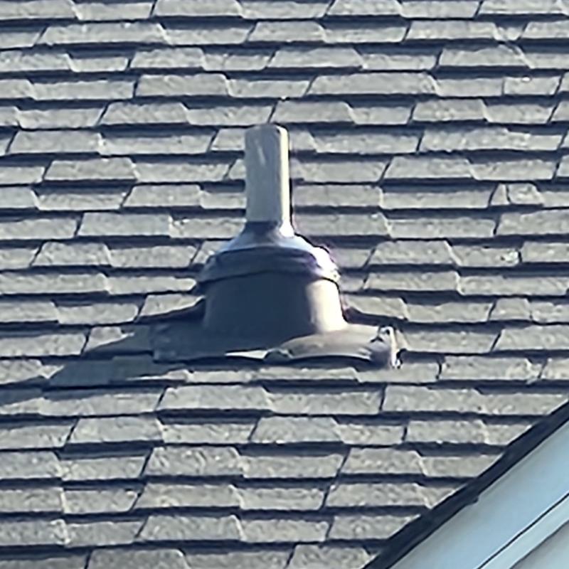Roof vent flashing damage on aged shingled roof