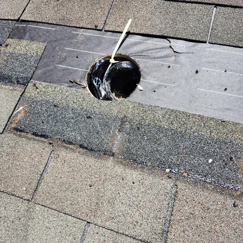 Roof vent boot with damaged shingles and flashing