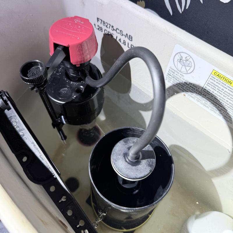 Toilet fill valve with new parts installed inside tank