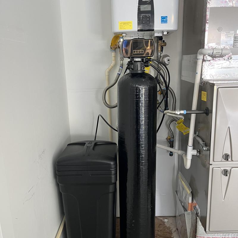 Water softener tank and brine tank installation in utility room
