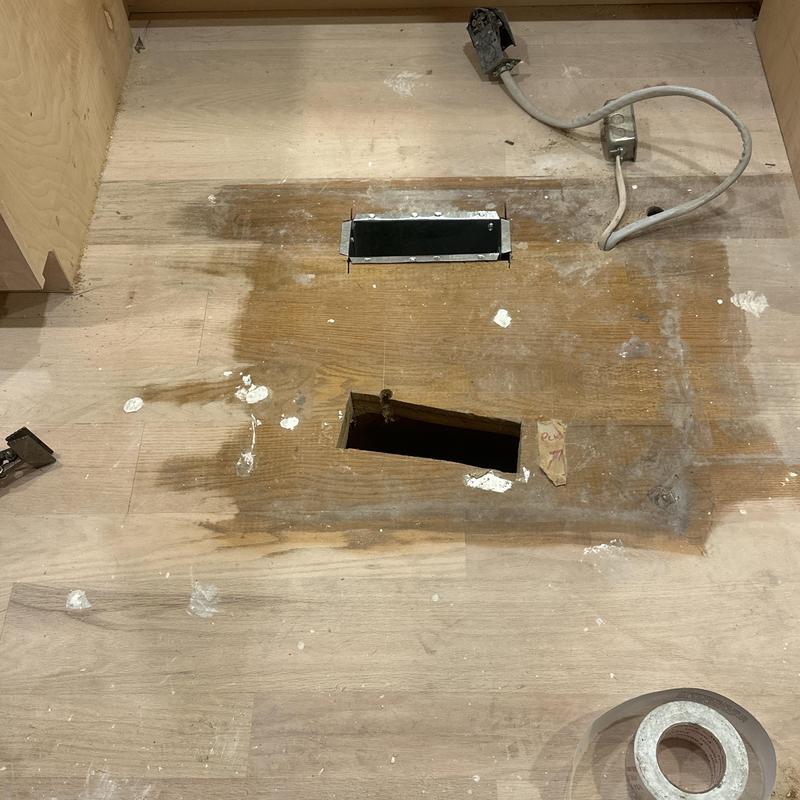 Exhaust vent repositioned on wooden floor panel