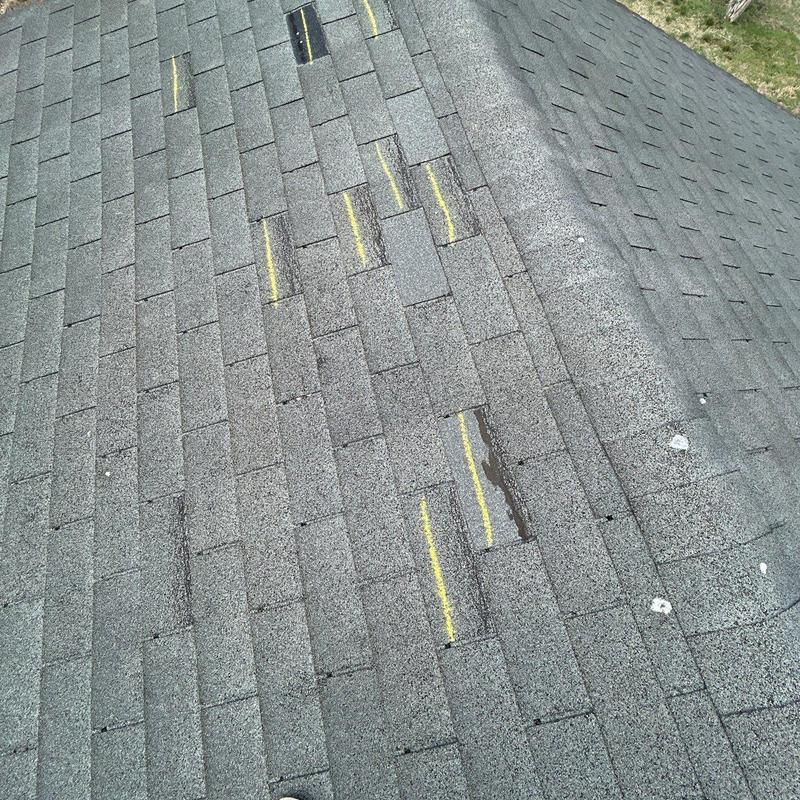 Asphalt shingle roof with hail damage markings