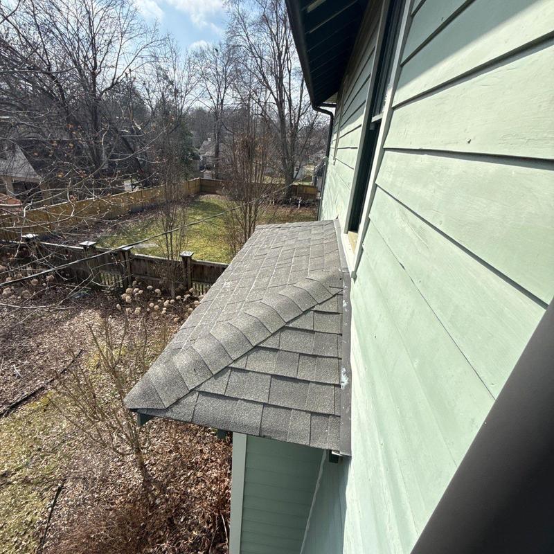 Asphalt shingle roof overhang with minor wear