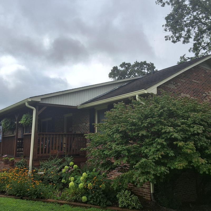 Asphalt shingle roof and gutter system on brick house
