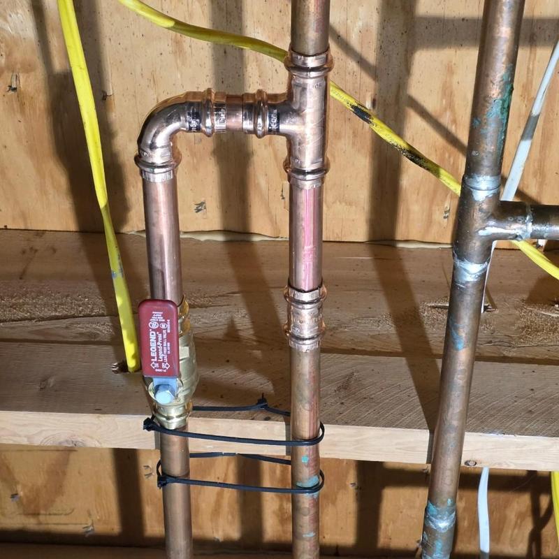 Copper tub shower valve with pipe fittings in basement Copper tub shower valve with pipe fittings in basement