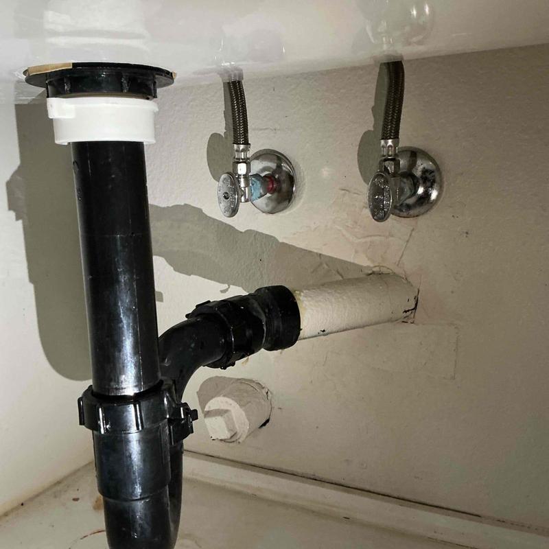 Angle stop valves under utility sink in laundry room