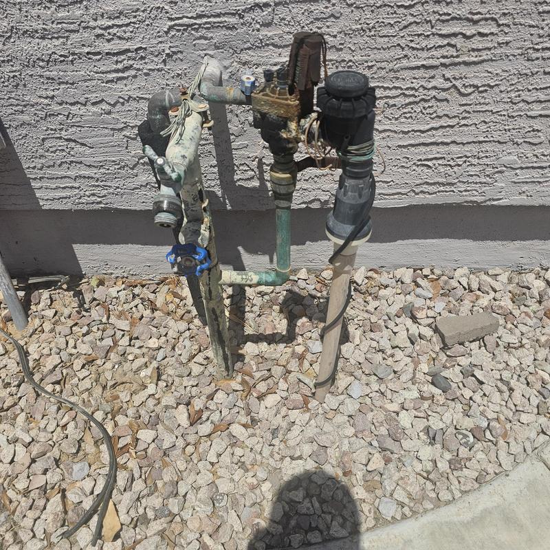 Mainline water valve and pipe assembly outside house Mainline water valve and pipe assembly outside house