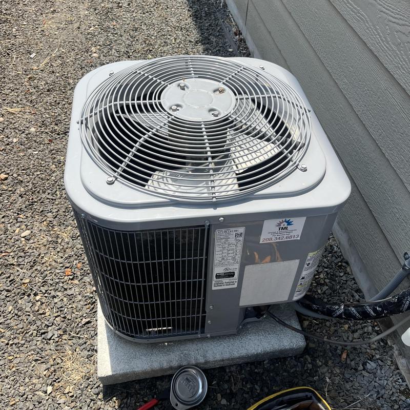 Air conditioner condenser unit with refrigerant line and fan