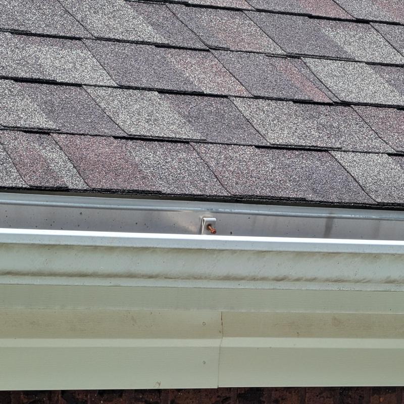 Asphalt shingle roof with metal drip edge and gutter