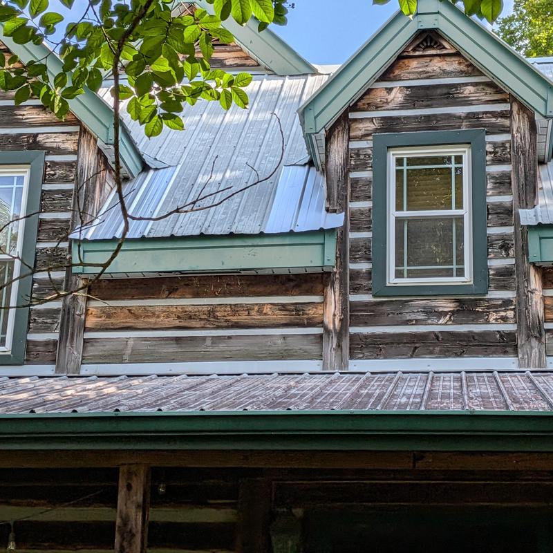 Metal roof with improperly installed panels on cabin