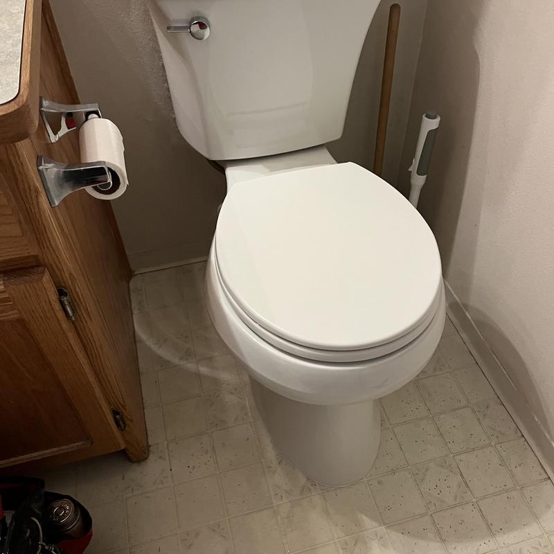 Toilet installation with closed lid in small bathroom