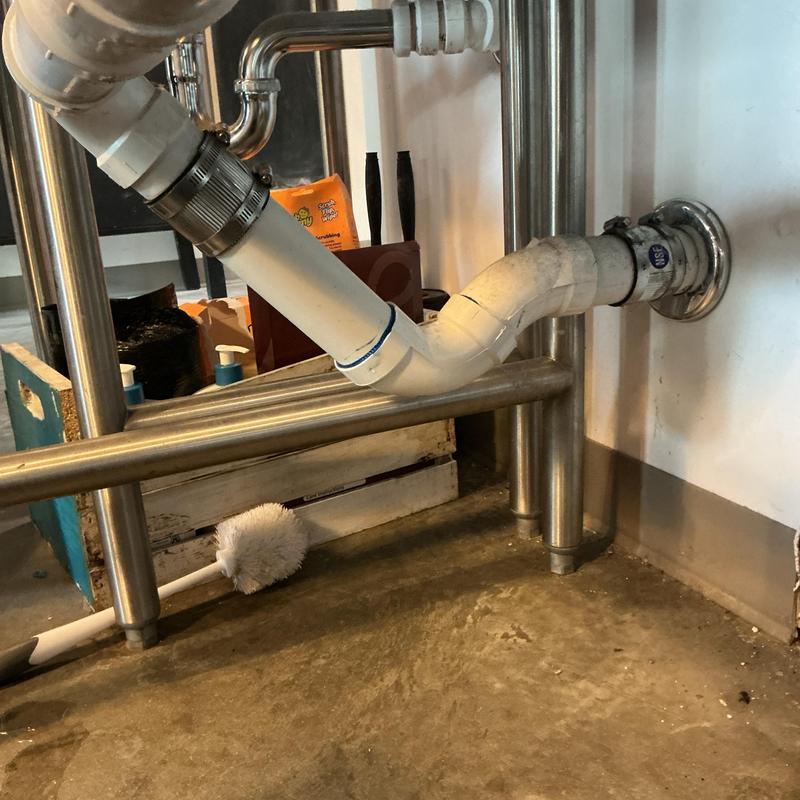 PVC drain pipe under sink with metal supports