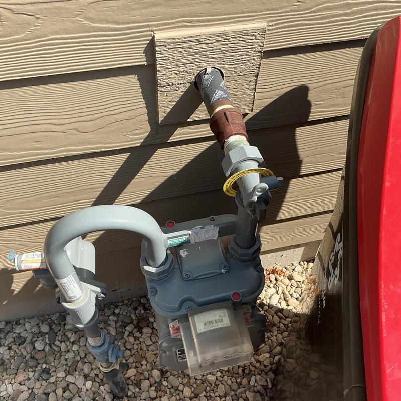 Gas meter with service line connection at home exterior