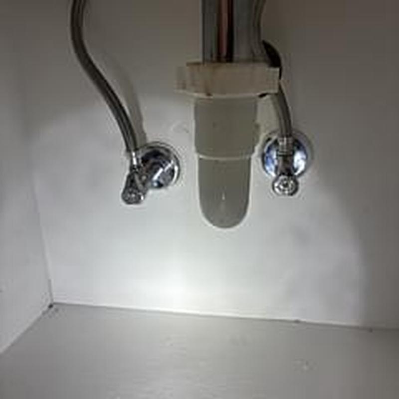 Shut off valves under sink with plumbing pipes Shut off valves under sink with plumbing pipes